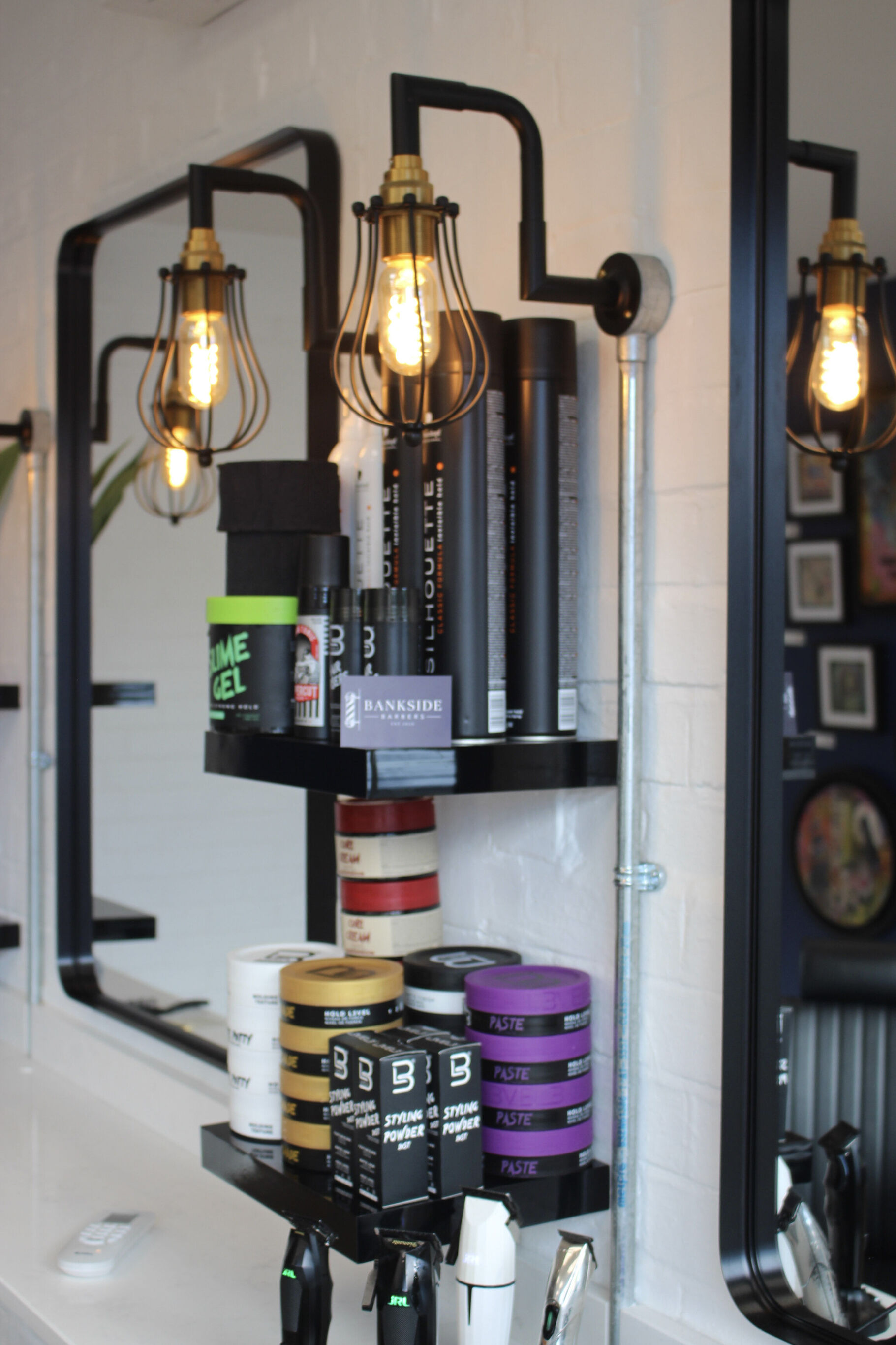 Shelf of styling products beside the mirror