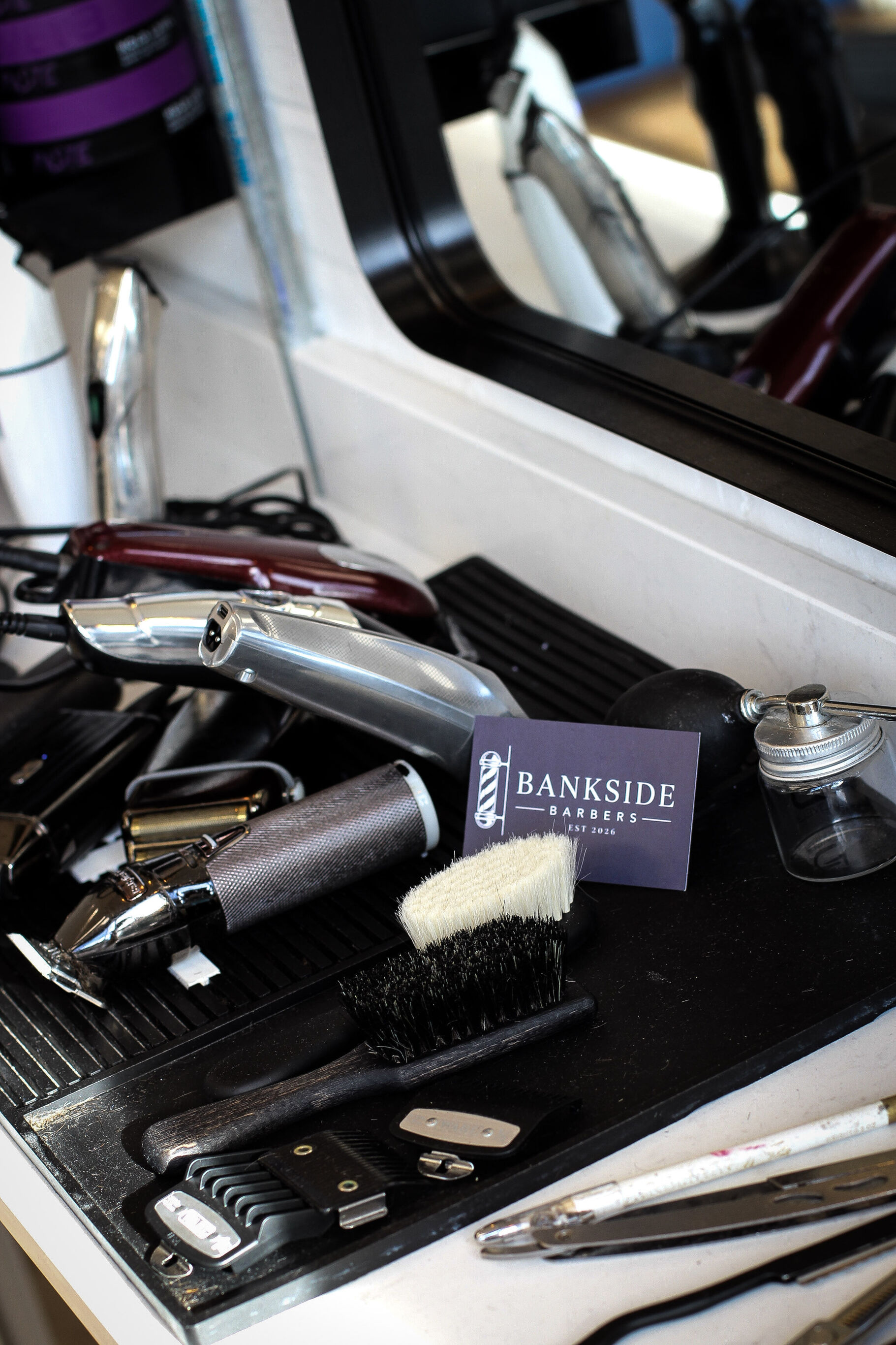 Clippers and a neck brush laid out on the station