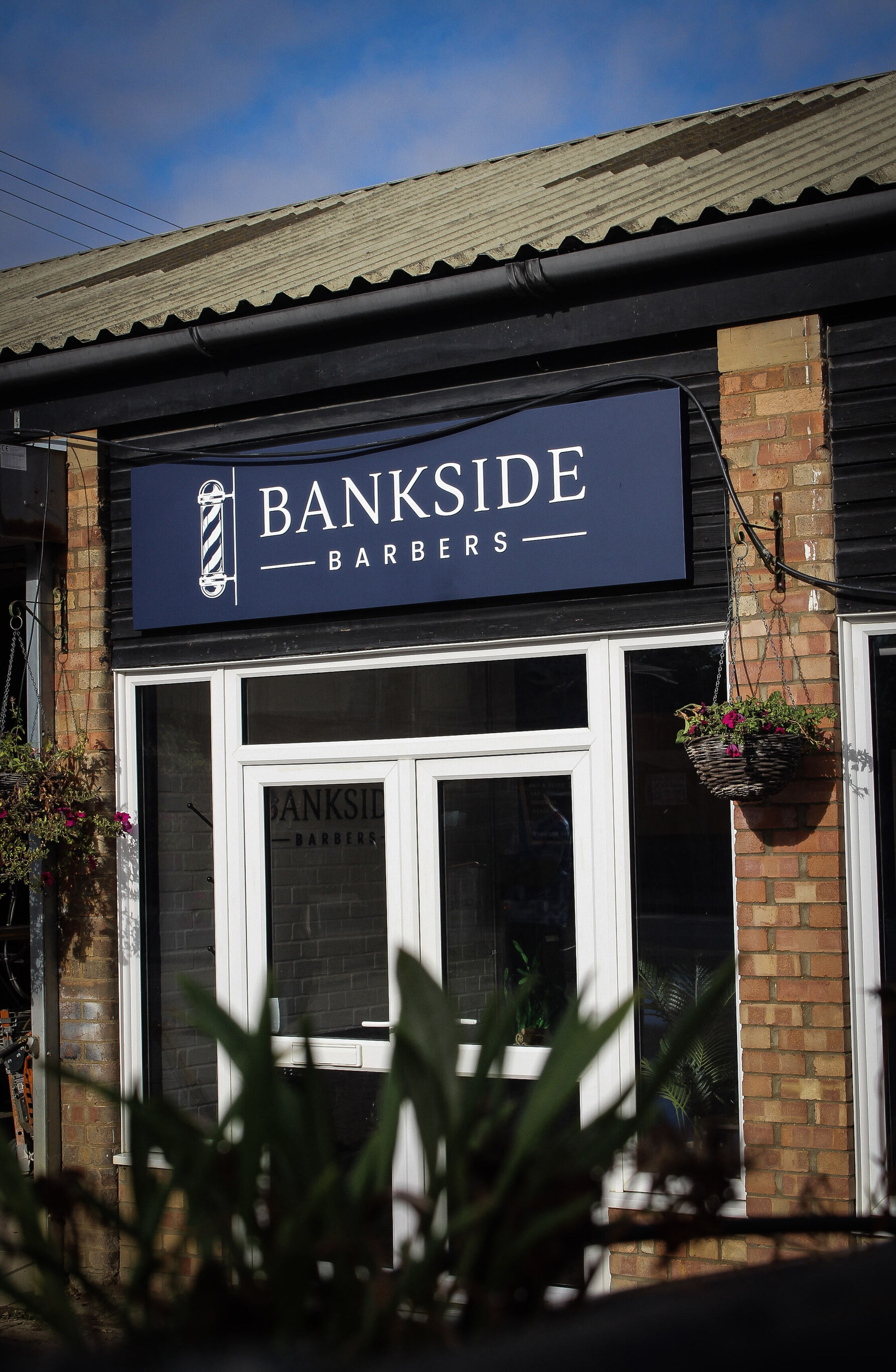 Shop doors under the Bankside Barbers sign