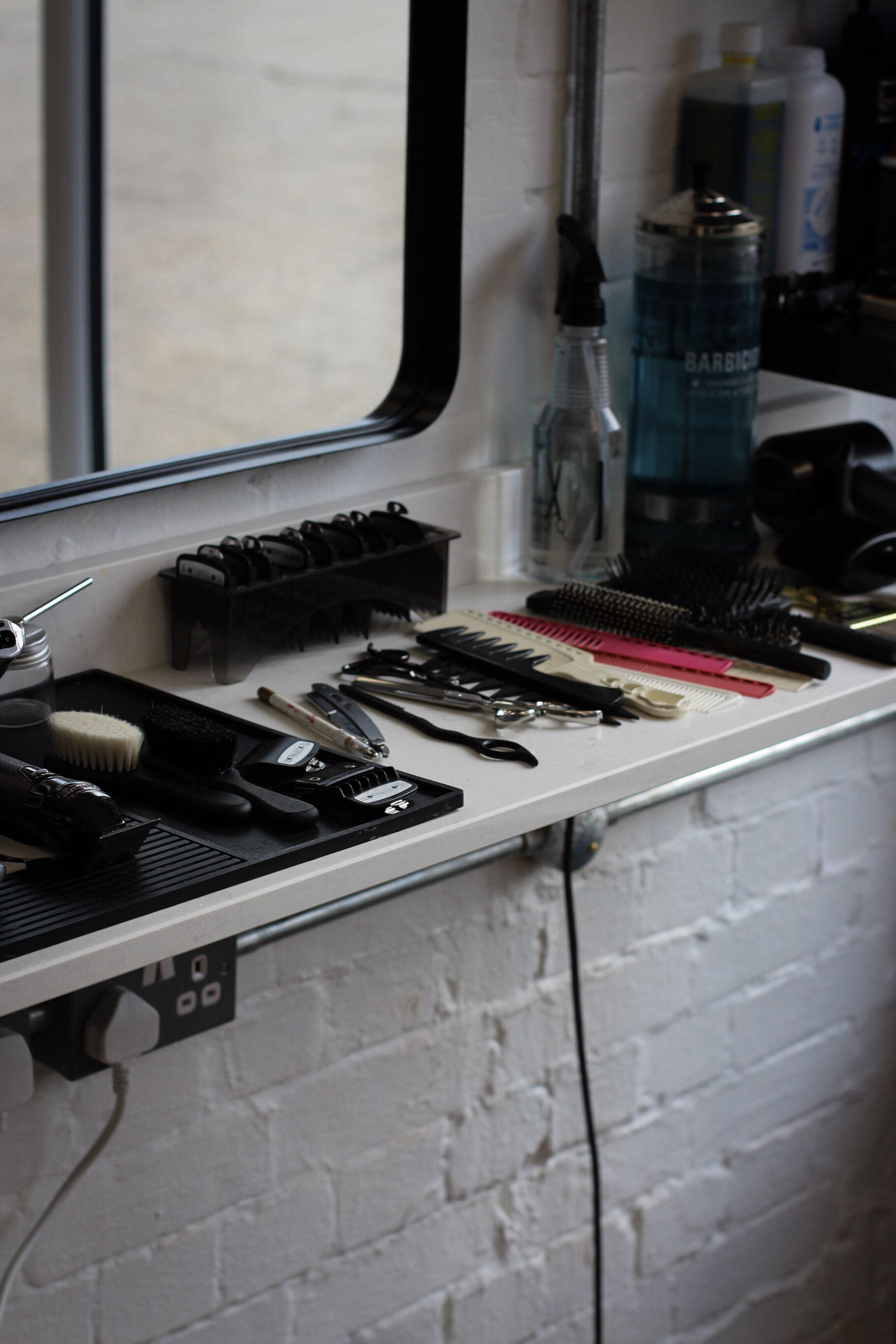 Clippers and trimmers along the counter by the mirror